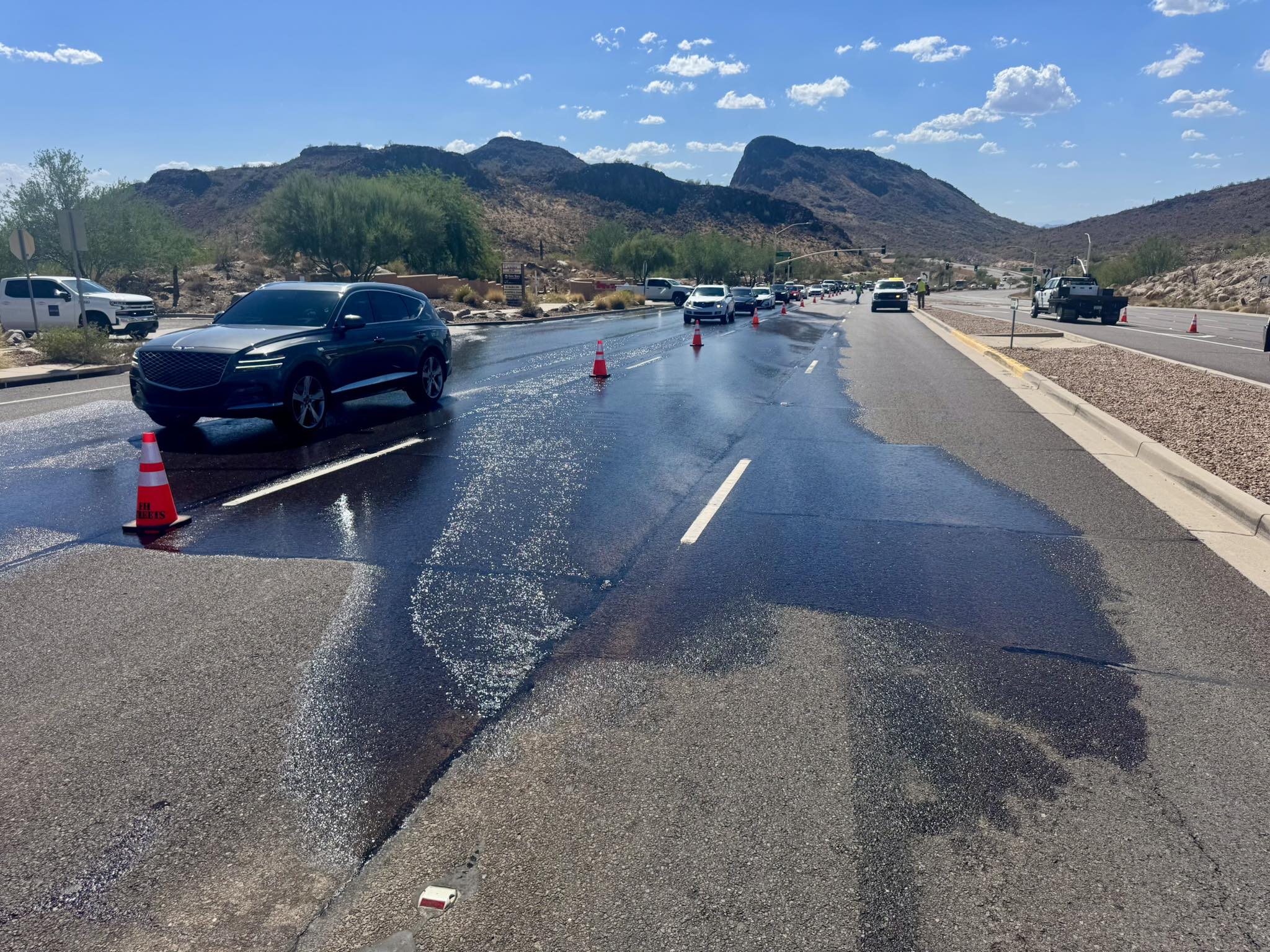 Water Main break along eastbound Shea Blvd with cars driving 
