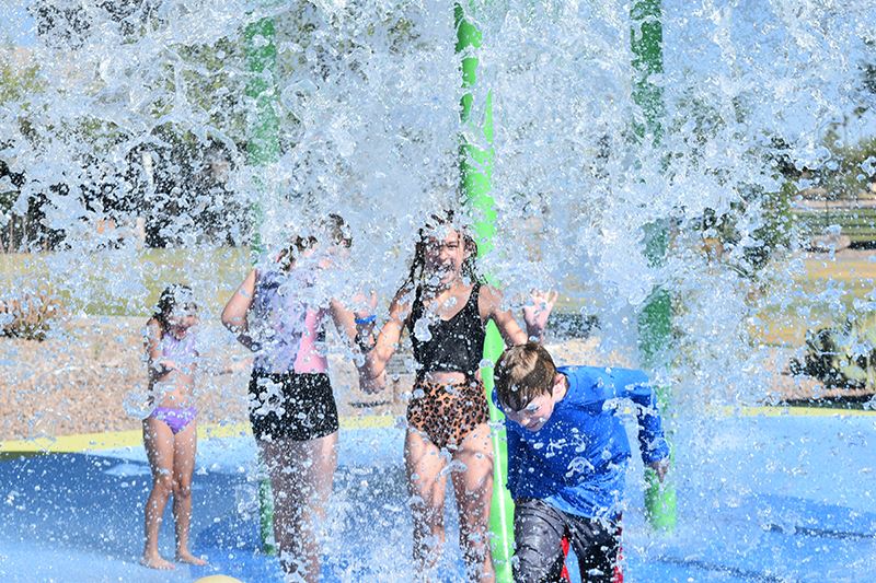 children get drenched at Rotary Splash Pad at Fountain Park.