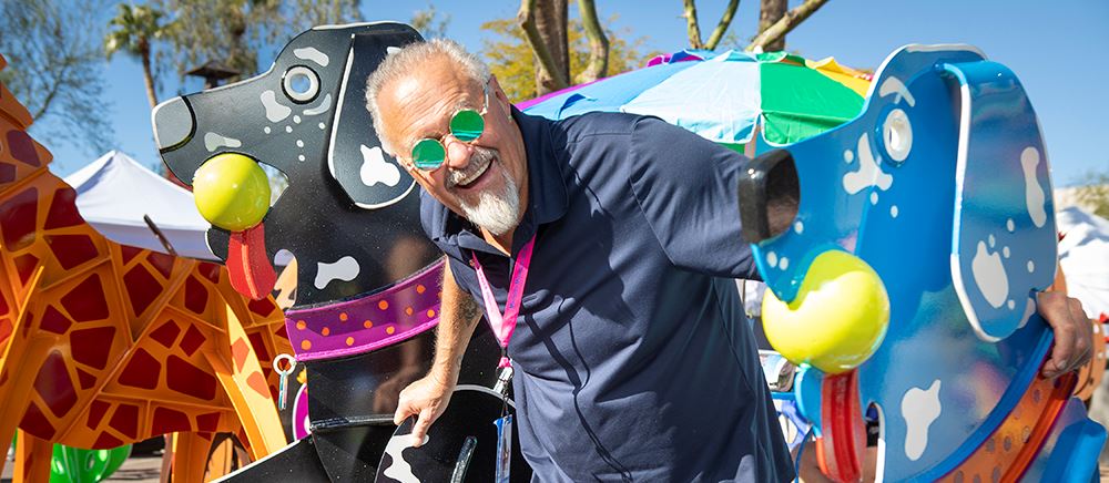 Shopper checking out the dog artwork at the Festival of Fine Arts and Crafts